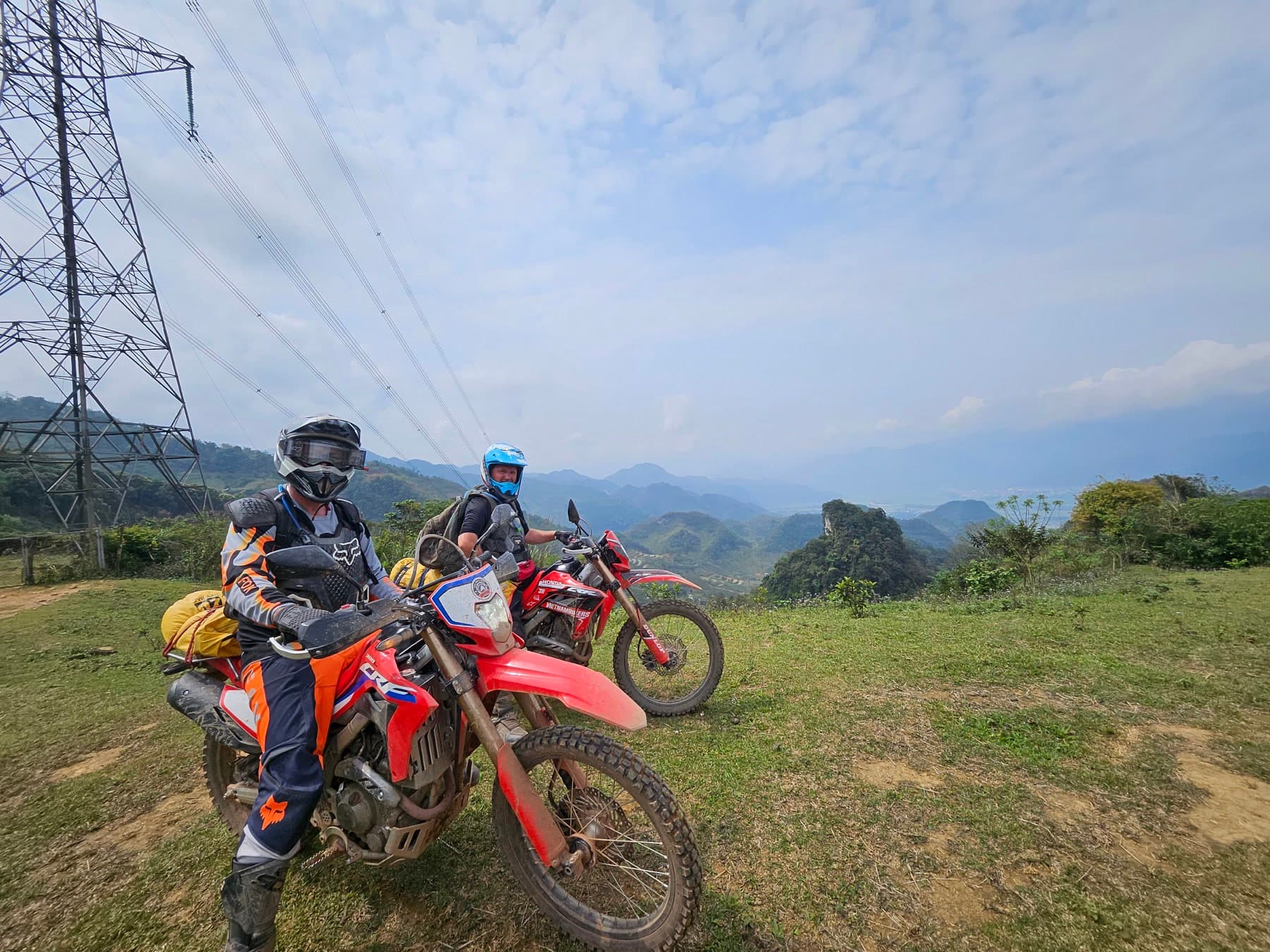Two dirt bike riders stopped on a high Northern Vietnam ridge
